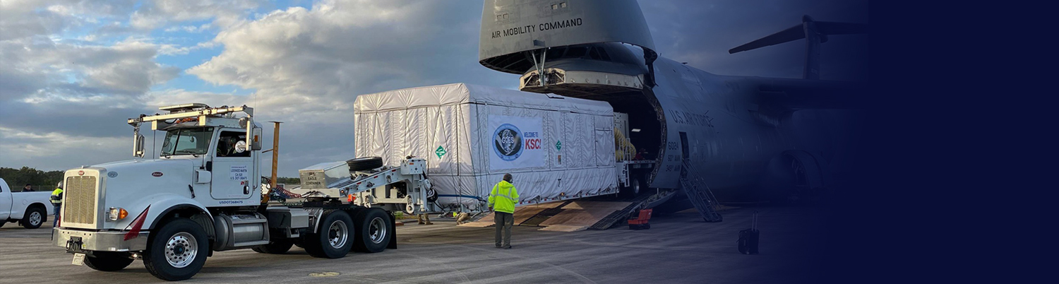 Image of GOES Satellite being offloaded from a cargo plan at NASA/KSC