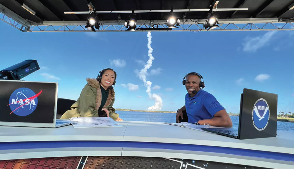 Kevin Fryar and NASA colleague sitting at broadcast desk during the GOES-T launch broadcast
